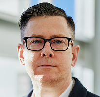 Foto de Alexander Hughes, CEO e executivo de uma empresa de trading de criptomoedas